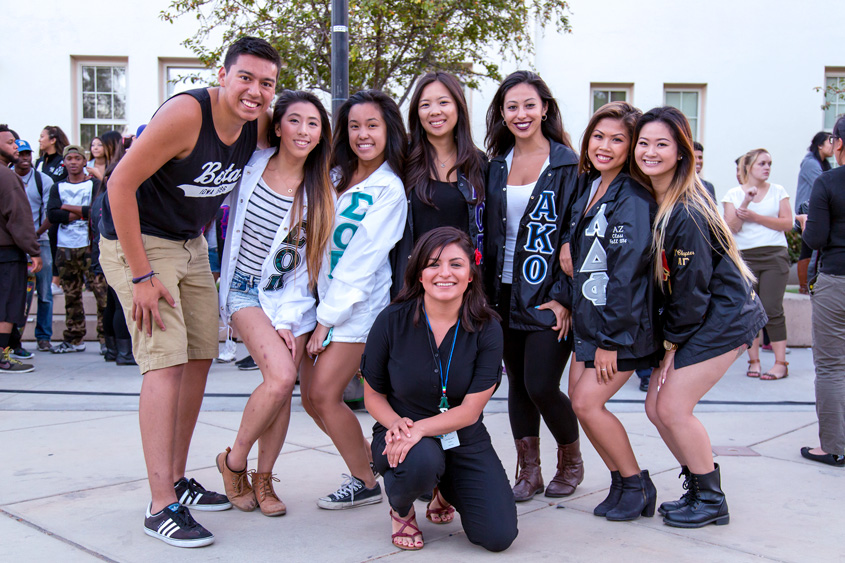 Fraternity and sorority members posing on the Paseo.