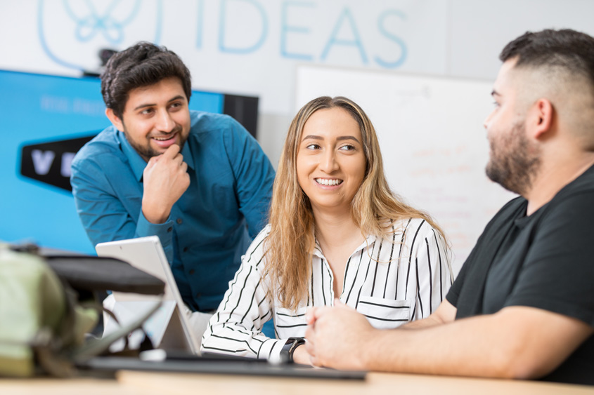 Three students working in the IDEAS lab at SJSU.