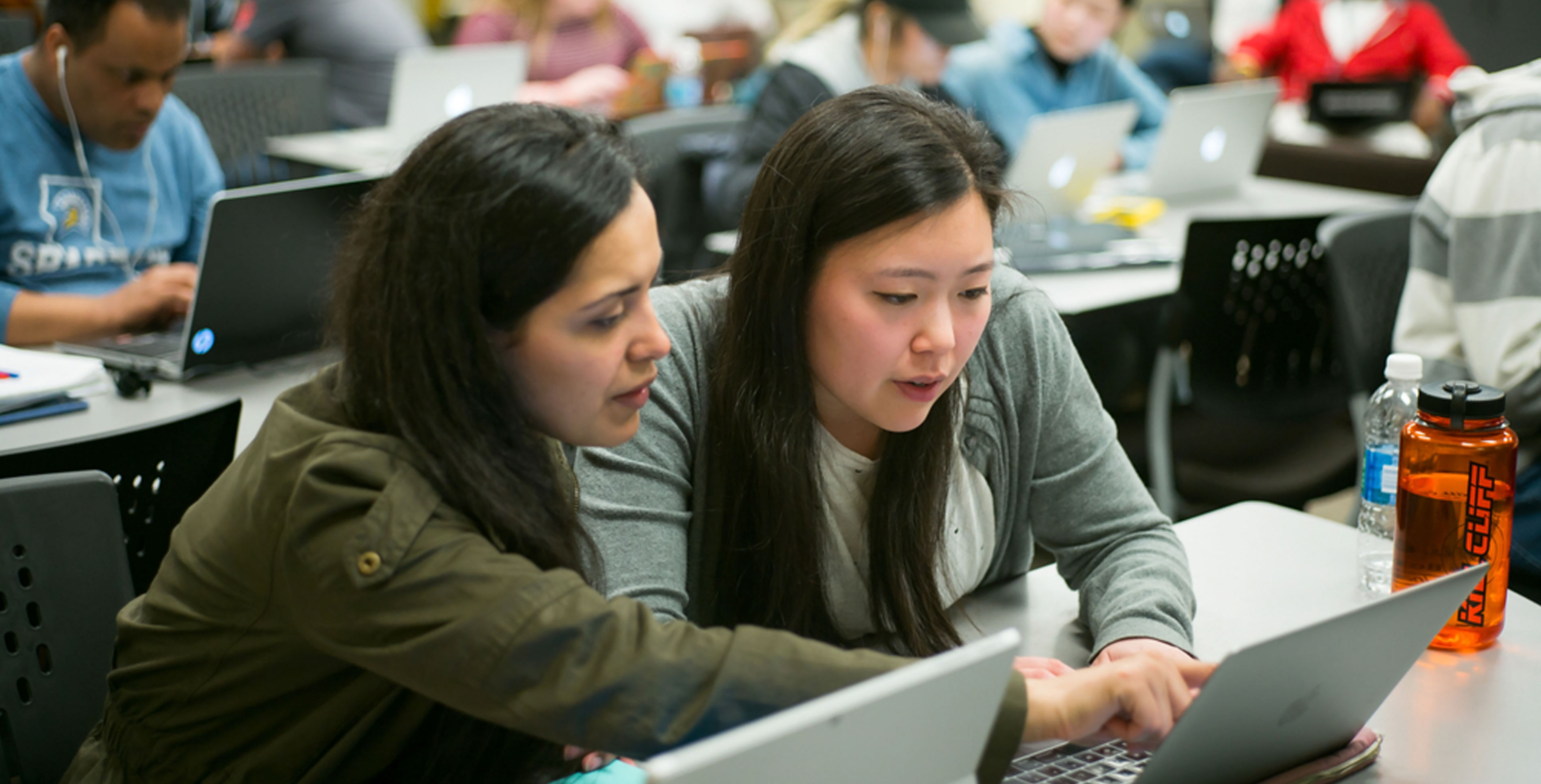 Two SJSU students working on their computers.