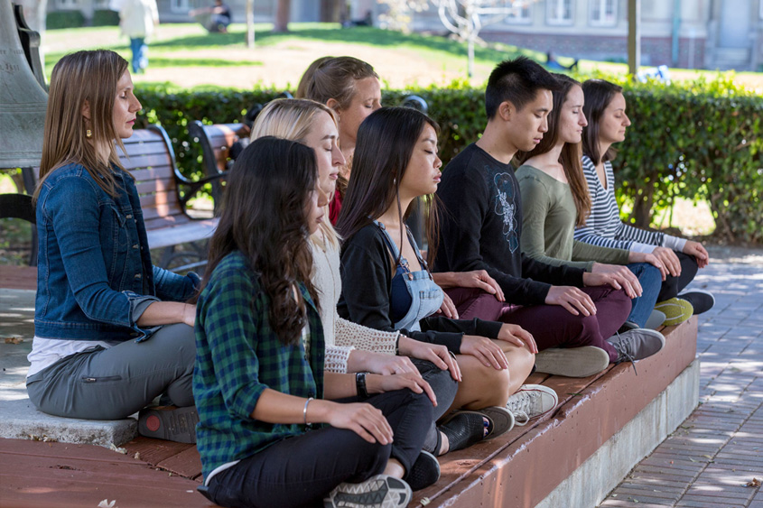 Students meditating on campus.