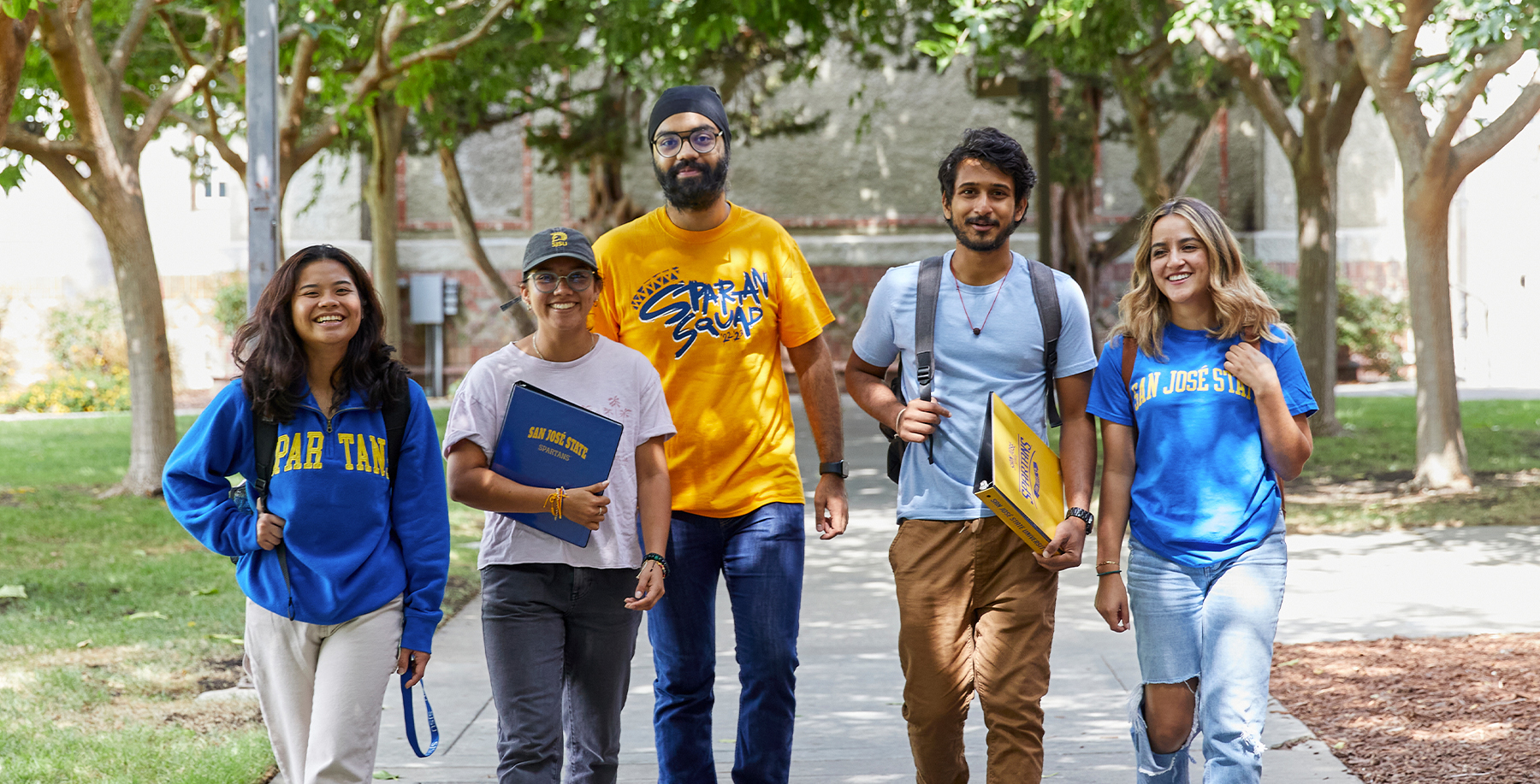 Students walking under trees