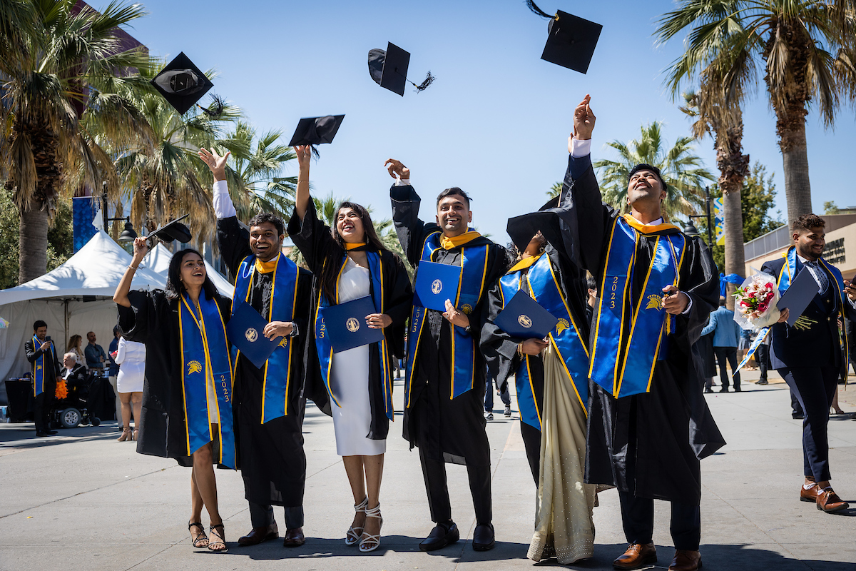 Grads throwing caps