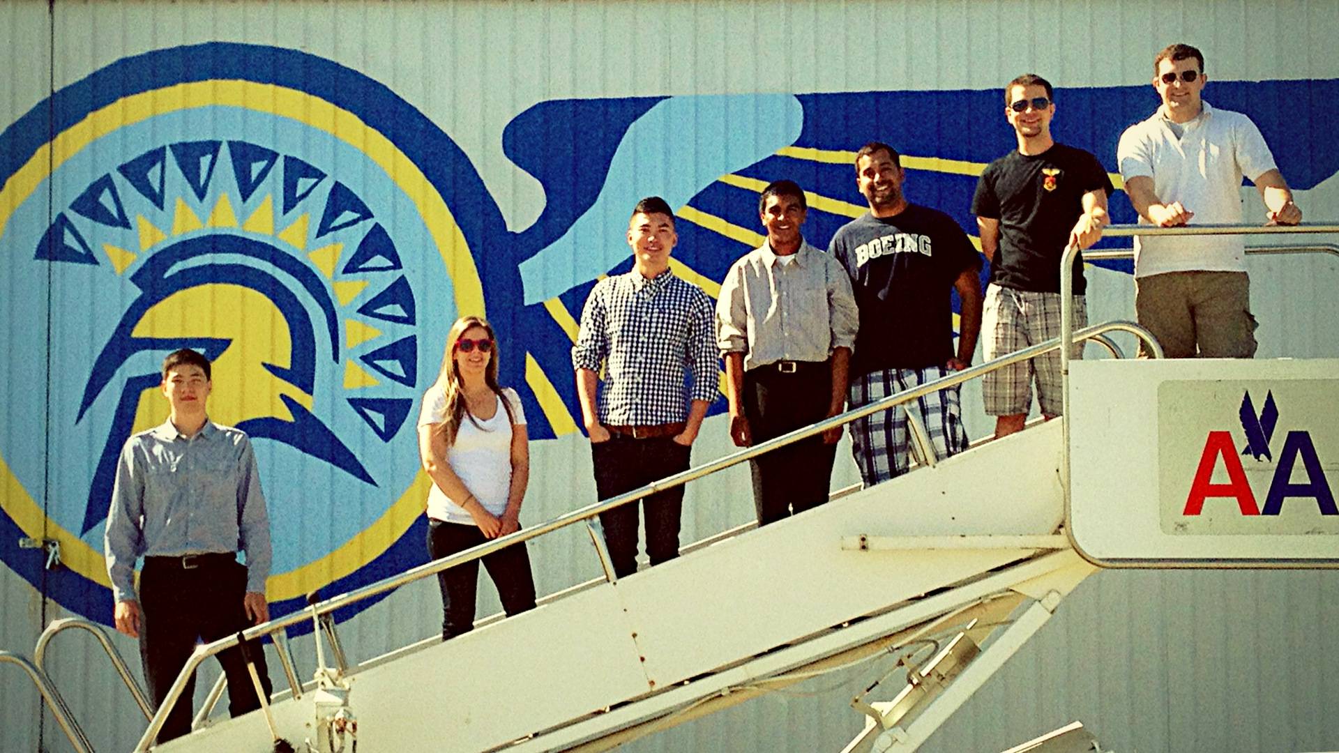 Aviation students posing infront of the hanger at Reid-Hillview Airport