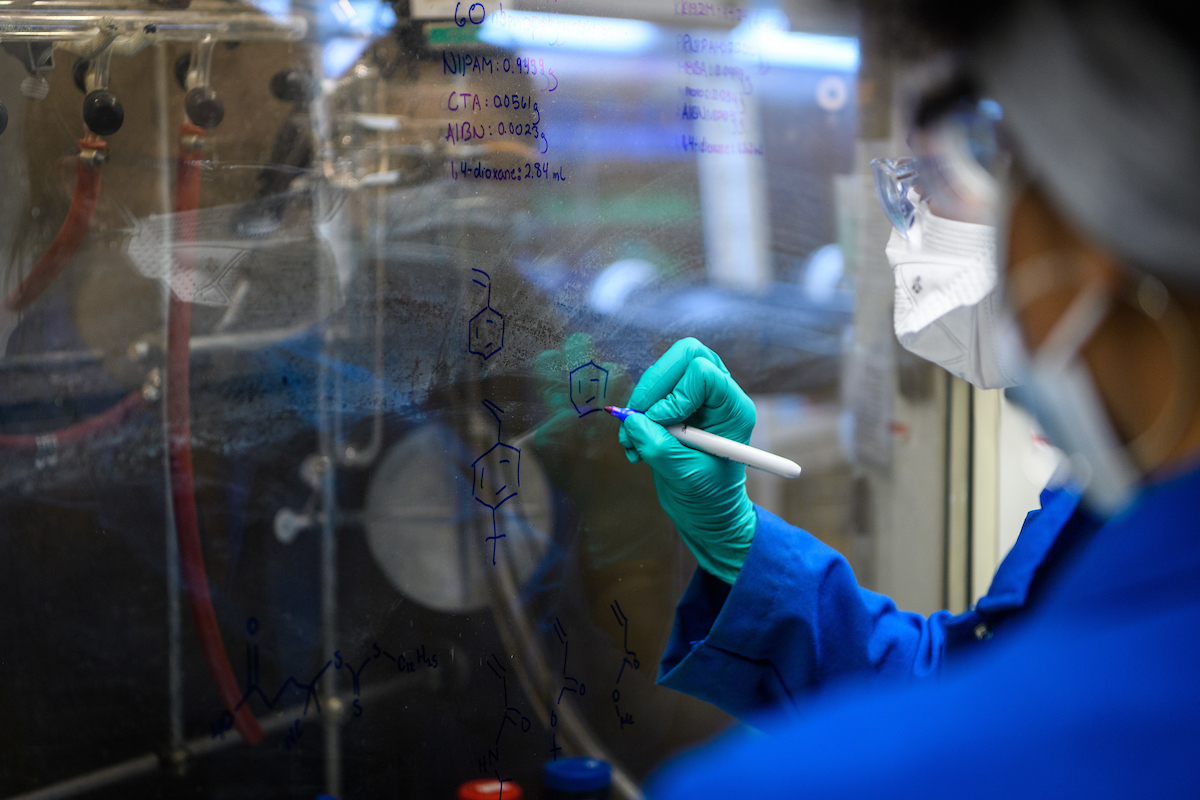 student in a lab writing