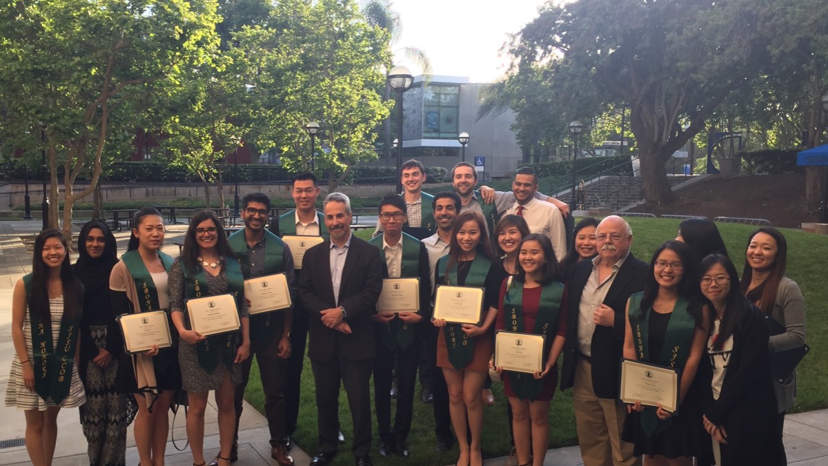 Accounting and Finance students with certificates and graduation stoles