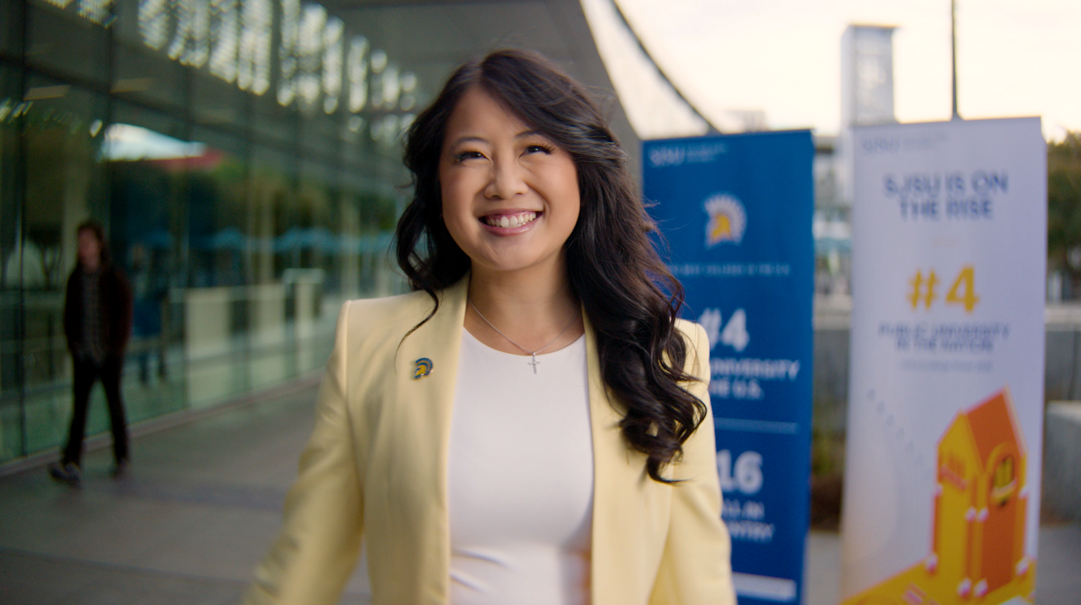 Nina Chuang (Class of 23) Standing in front of posters stating SJSU is the #4 Public University in the Nation