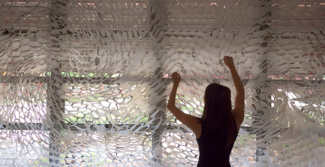 Woman pulling on a curtain