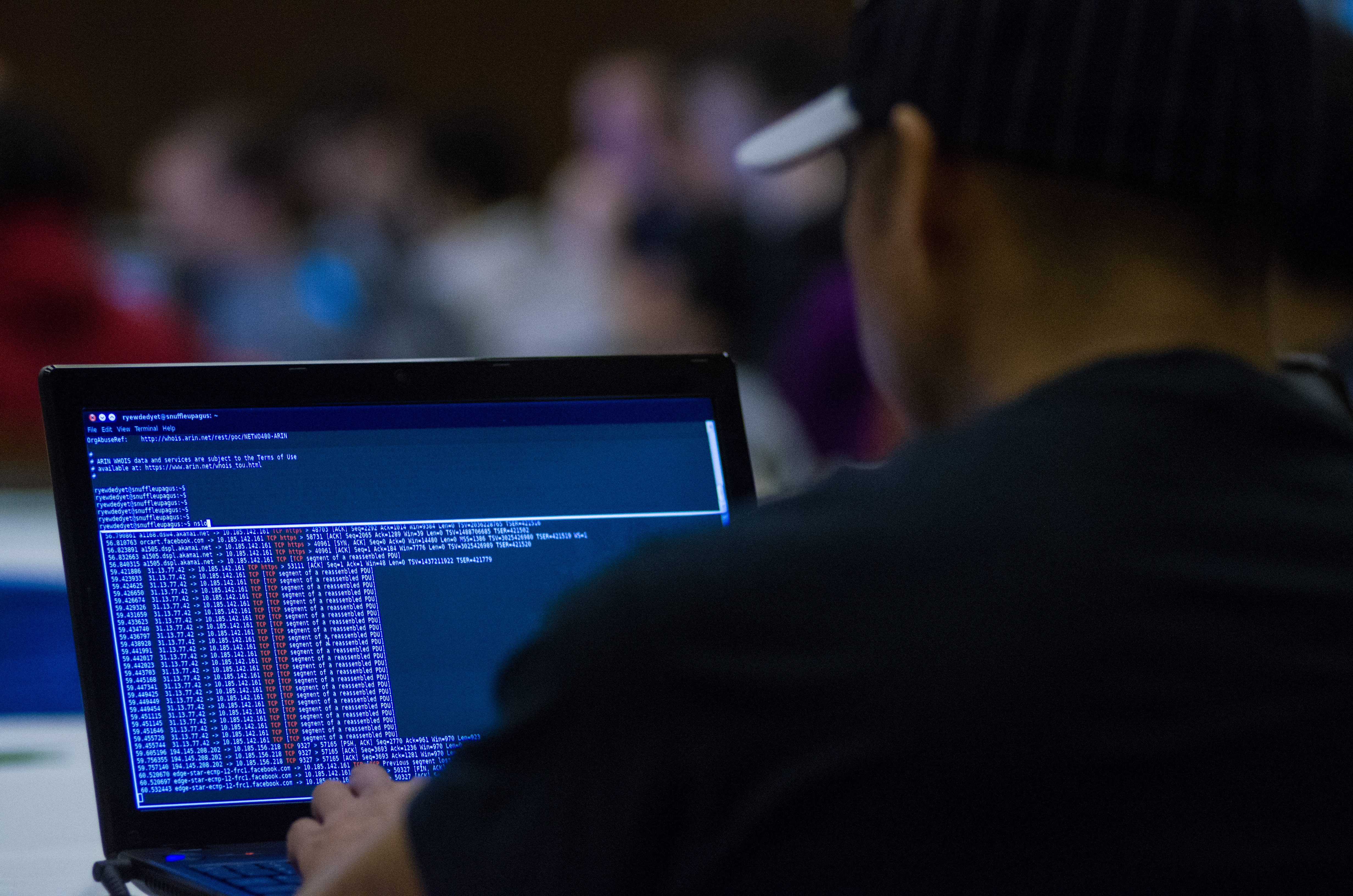  A picture of a man typing code into a laptop computer. 