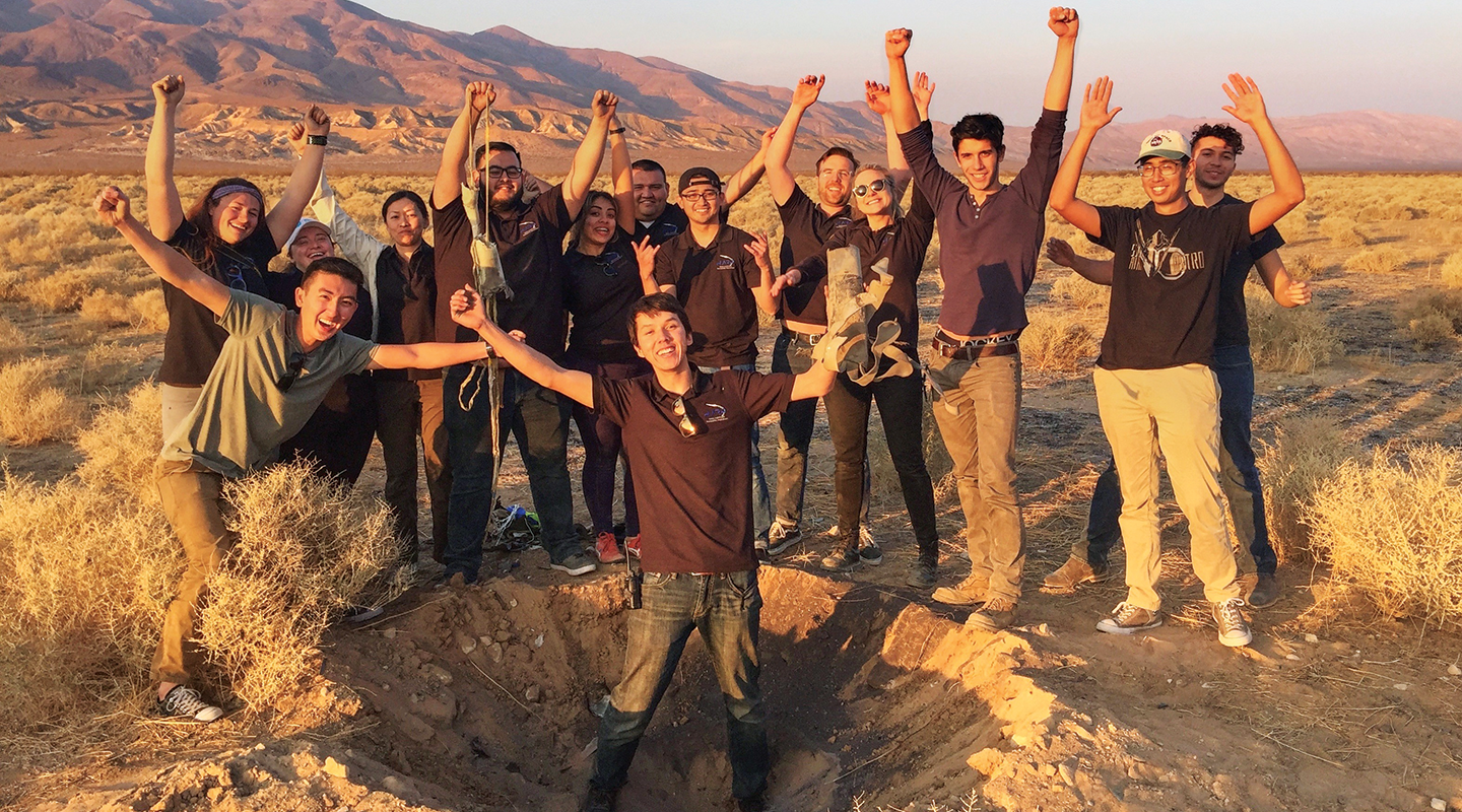 HARP team standing in crater