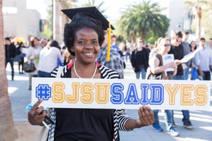 Student holding SJSU Said Yes banner