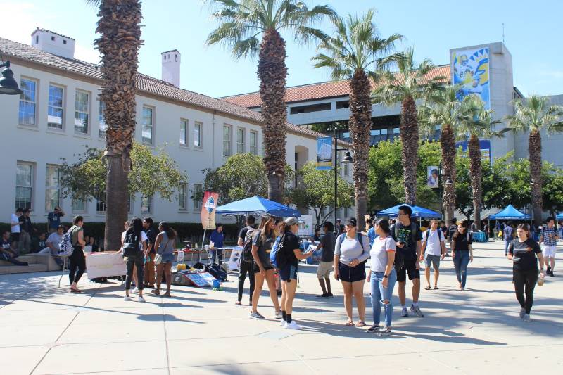 Group of SJSU students at club tables in quad area