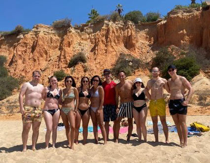 A gathering of former I-House residents on a sunny beach in Portugal