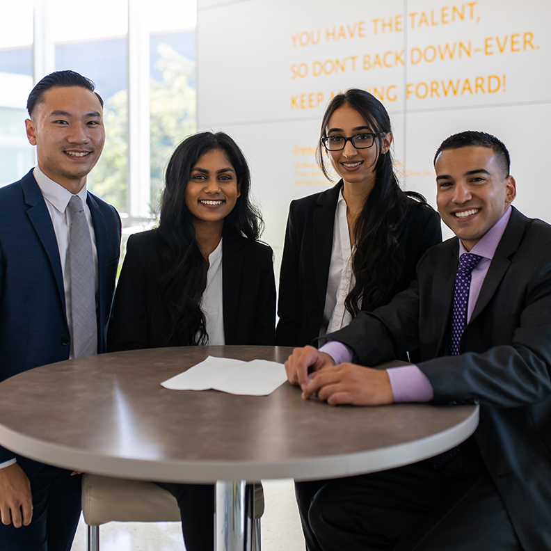 Business Students standing around table