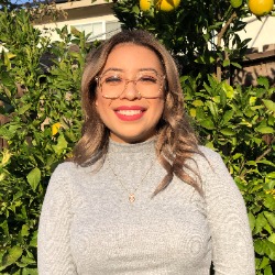 Headshot of graduate student Lisette Valenzeula under a lemon tree.