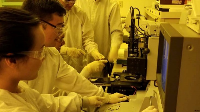 Several students using lab equipment in the MPEL.