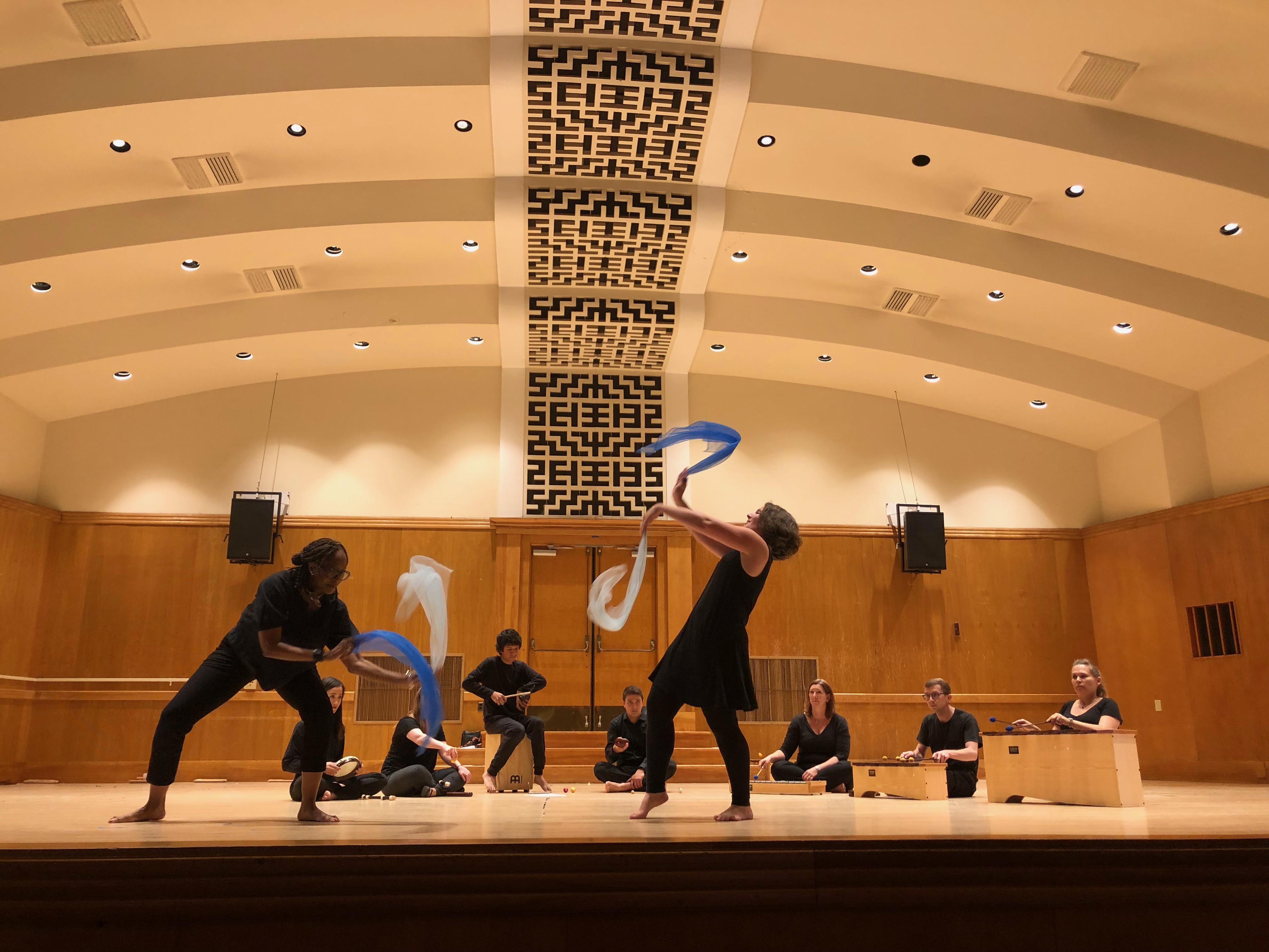 Students dancing on stage with ribbons at Orff training.