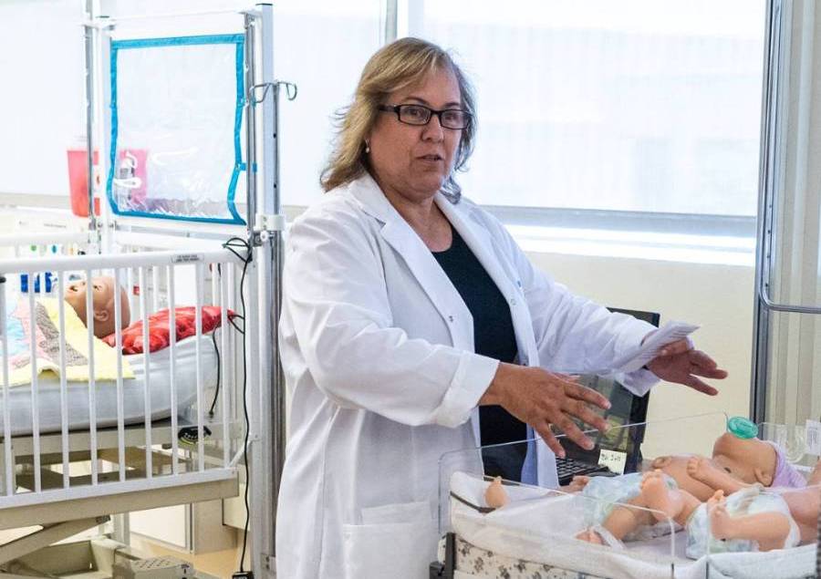 Lisa Rauch, TVFSON Professor and DNP holder, explains the OB equipment in the Sim Lab.