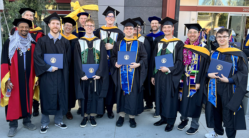 Group photo of SJSU students and faculty members in regalia.