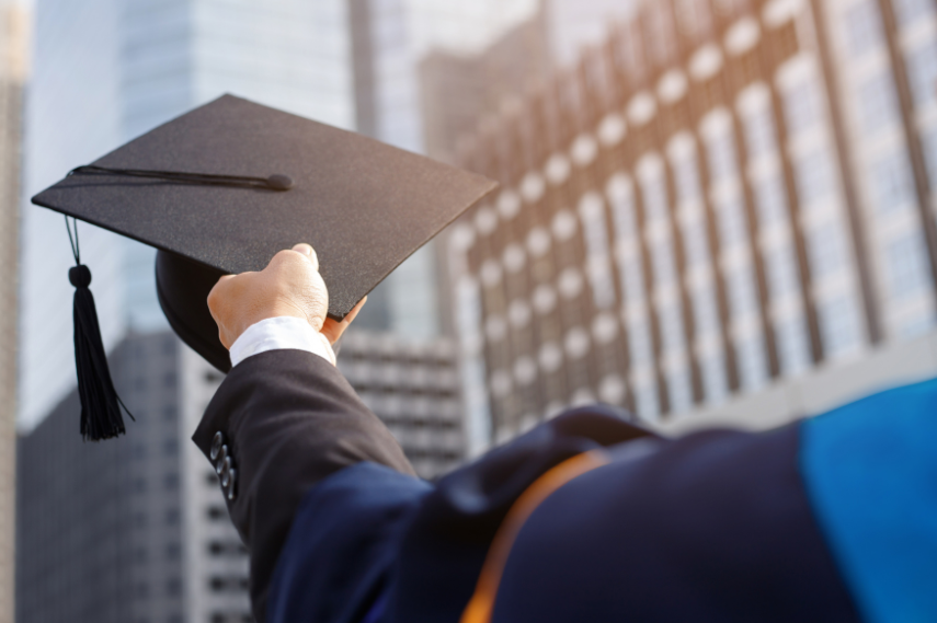 graduation cap being held up