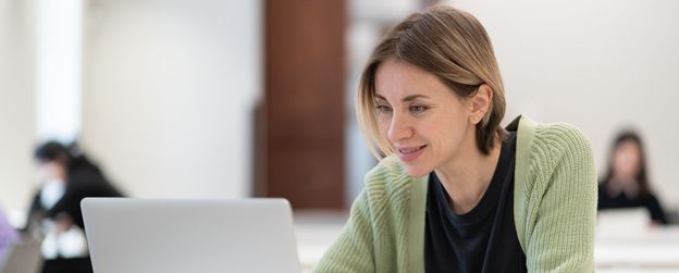 Woman looking at a laptop and smiling