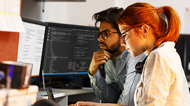 Two students studying on a computer together