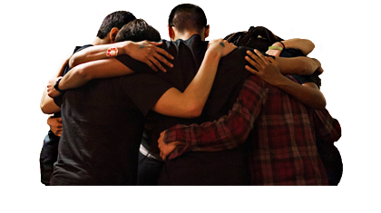 group of students stands in circle with arms around each other