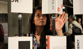 person turns an interactive shape at a library exhibit