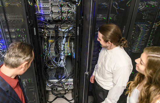 people look at large cabinet of electronic hardware