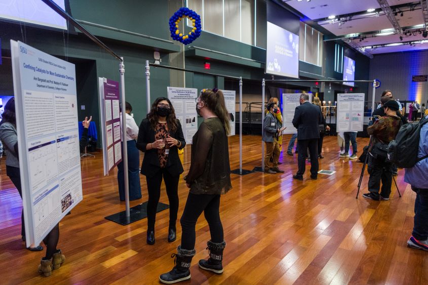 Students displaying their research posters. 