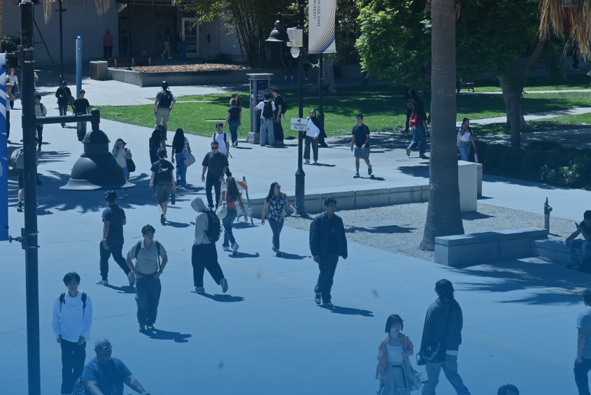 Students walking along the Seventh Street Plaza at SJSU.