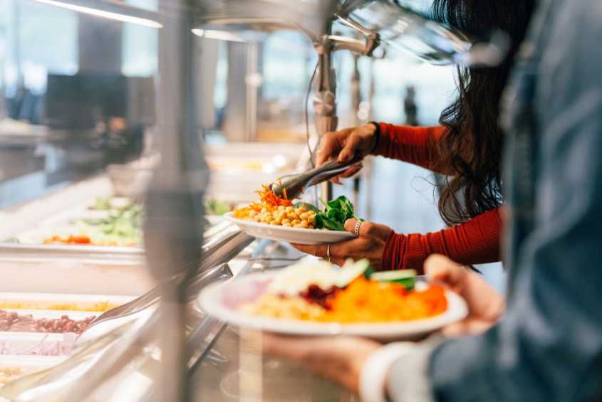 People getting food at a buffet