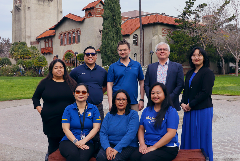 Staff with Faculty Services posing for a photo on Tower Lawn.
