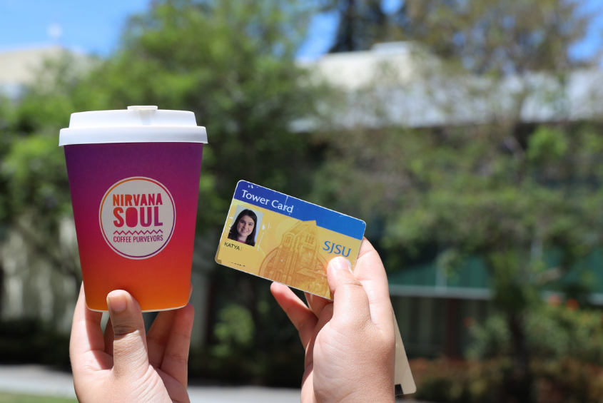A staff member holding a Nirvana Soul cup and Tower ID Card