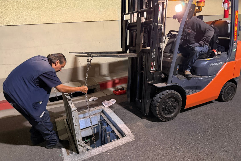 Facilities staff clearing storm drains.