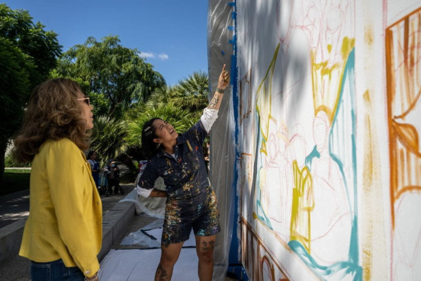 Artist Chi Chai Mateo and President Cynthia Teniente-Matson at the Filipino American Heritage Mural site.