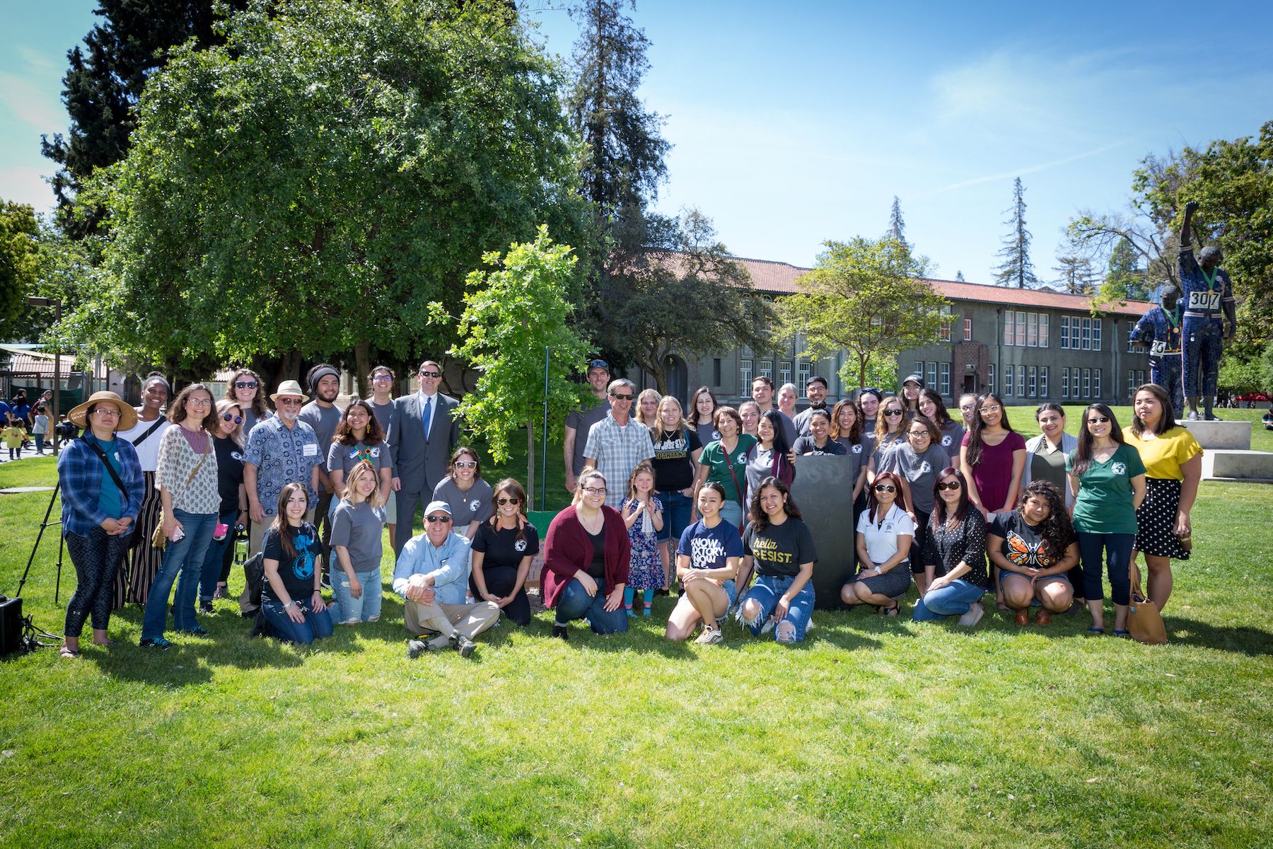 A group of people posing on the Smith Carlos lawn.