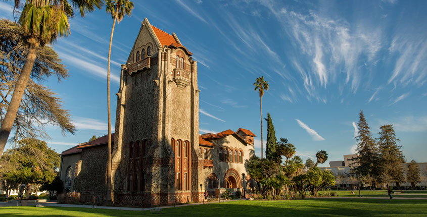 Tower Hall is lit by a sunset on SJSU campus.