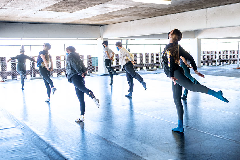 SJSU dancers mid-dance in the parking garage.